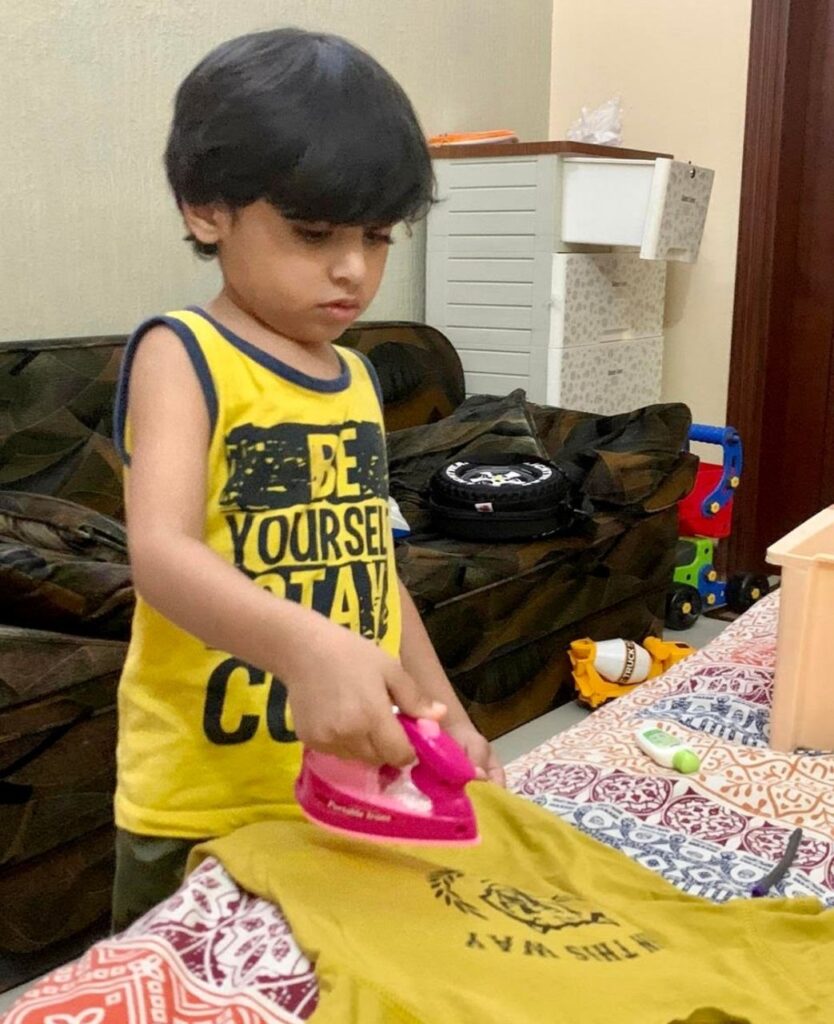 boy ironing clothes
