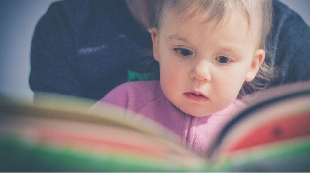 parent reading to a toddler encourages reading habits