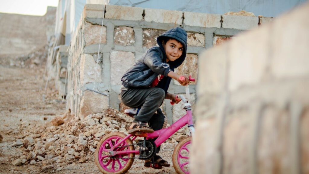 boy with pink bicycle